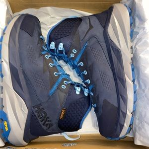 Hoka running shoes brand high top hiking boots.